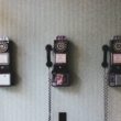 3 Dial phones on a wall