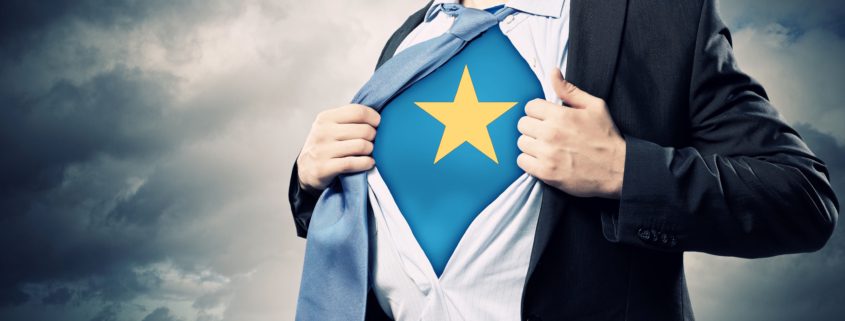 Person holding open shirt revealing a star superhero logo