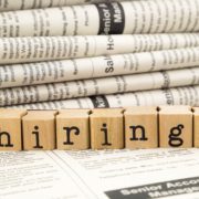 Folded position listings with letter stamps forming the word 'hiring!' in front