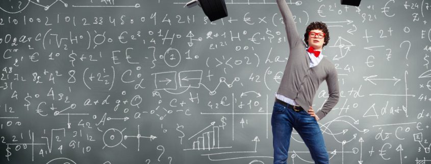 Man holding up a barbell weight standing in front of a chalkboard with different graphs and equations on it
