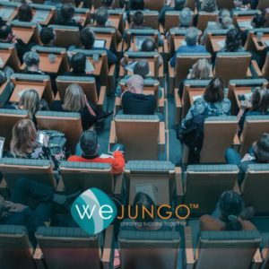 Group of people sitting in a lecture hall with Wejungo logo labeled